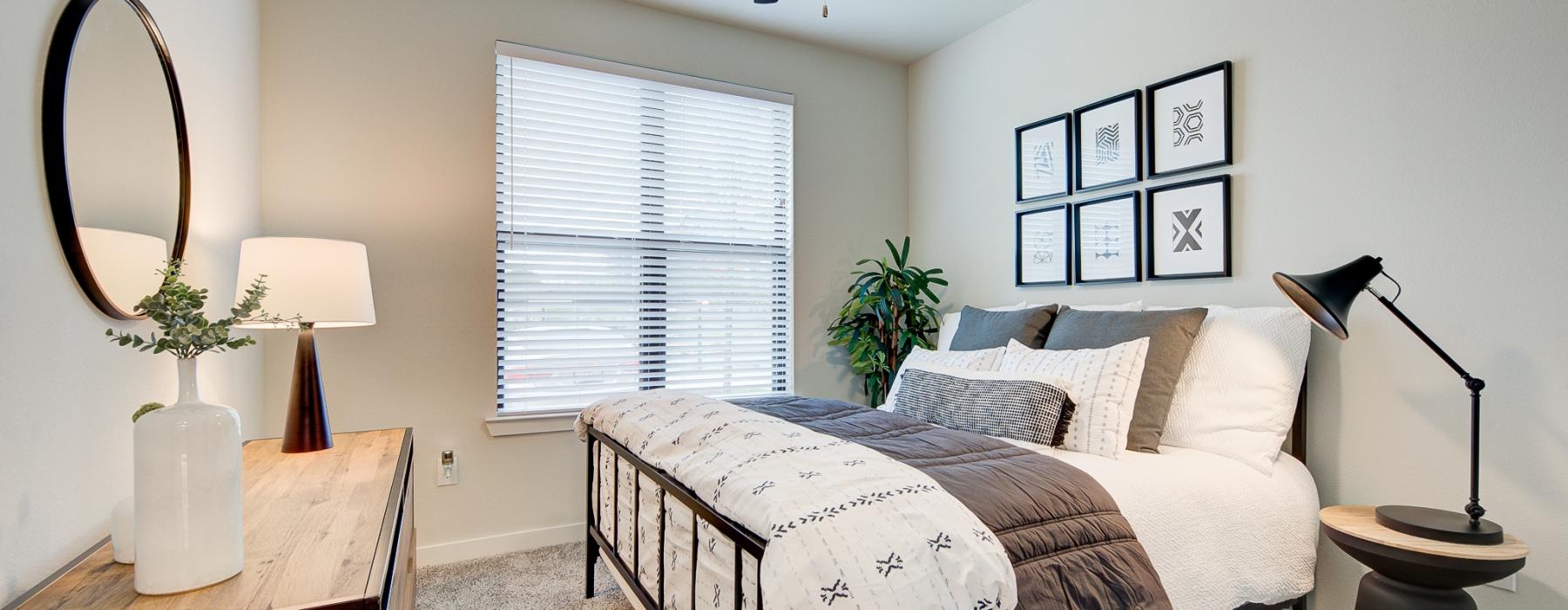 a bedroom with a bed and lamps