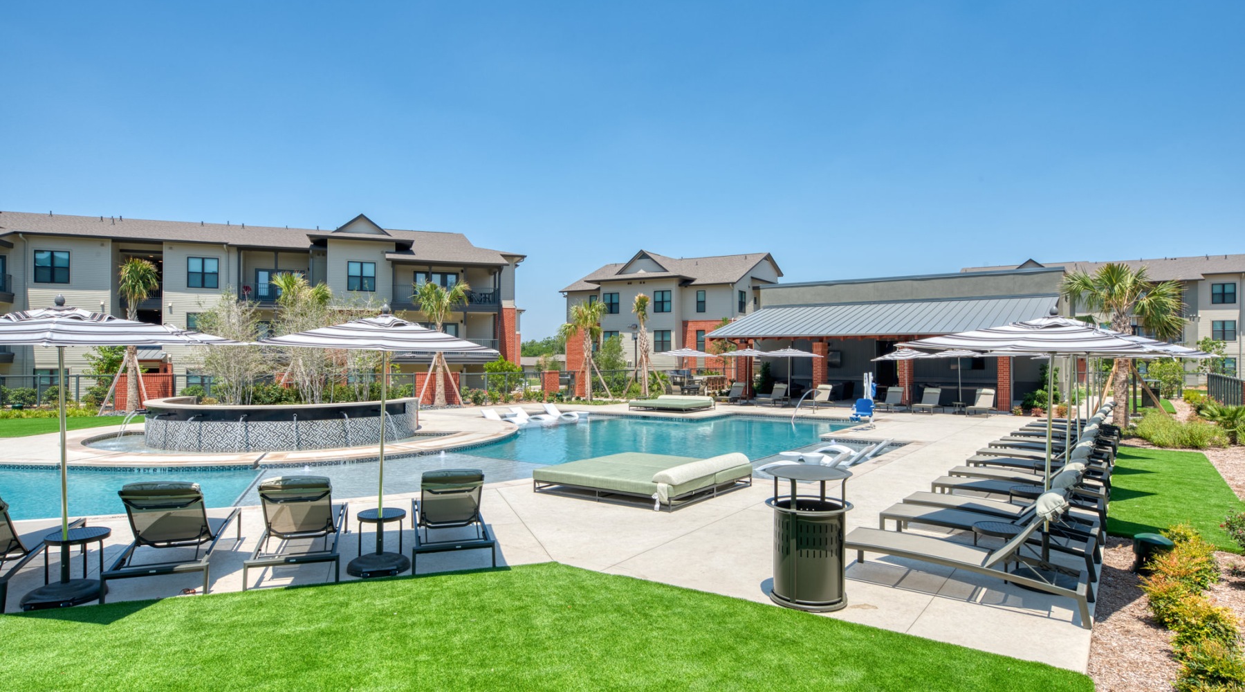 a pool with chairs and umbrellas by it