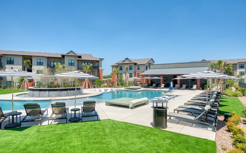a pool with chairs and umbrellas by it