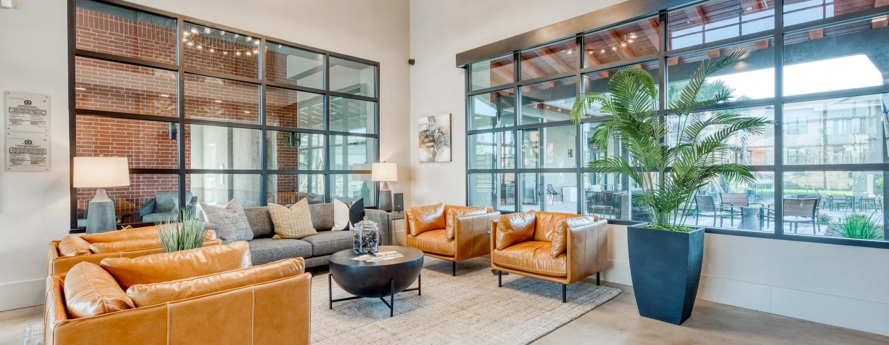a room with a large window and a couch and chairs