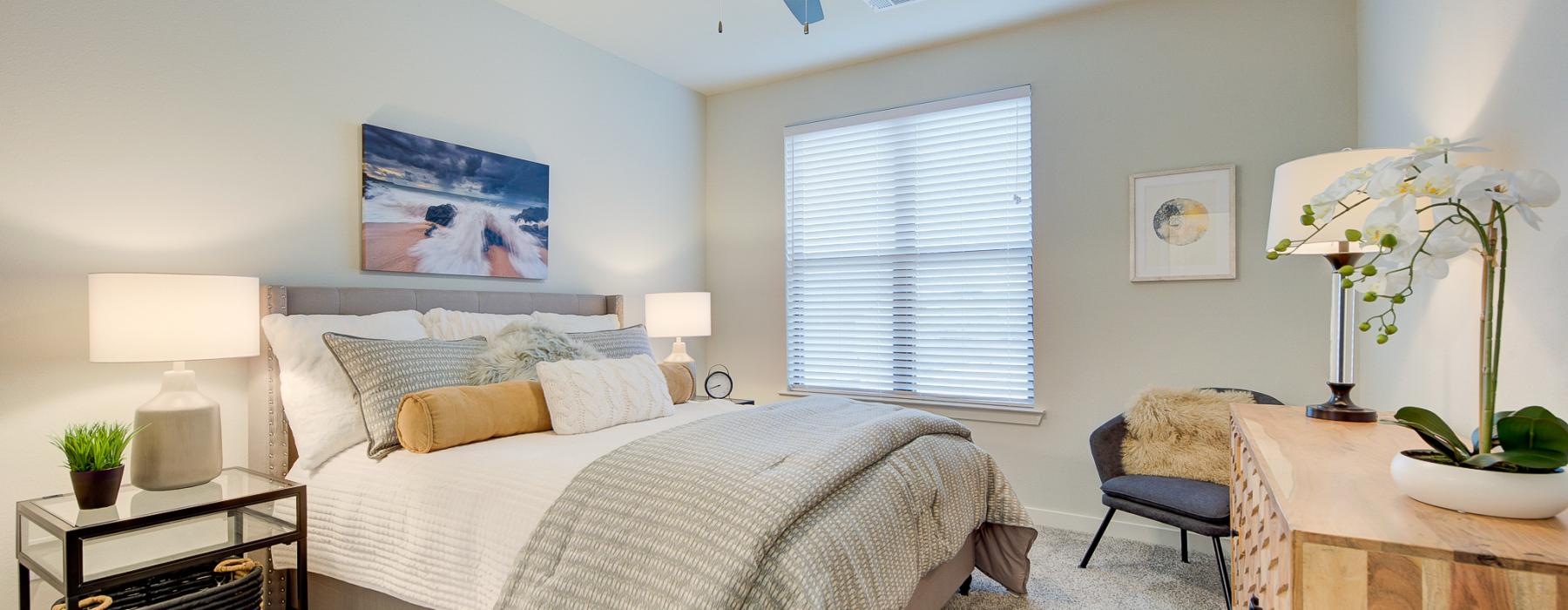 a bedroom with a bed and a fan