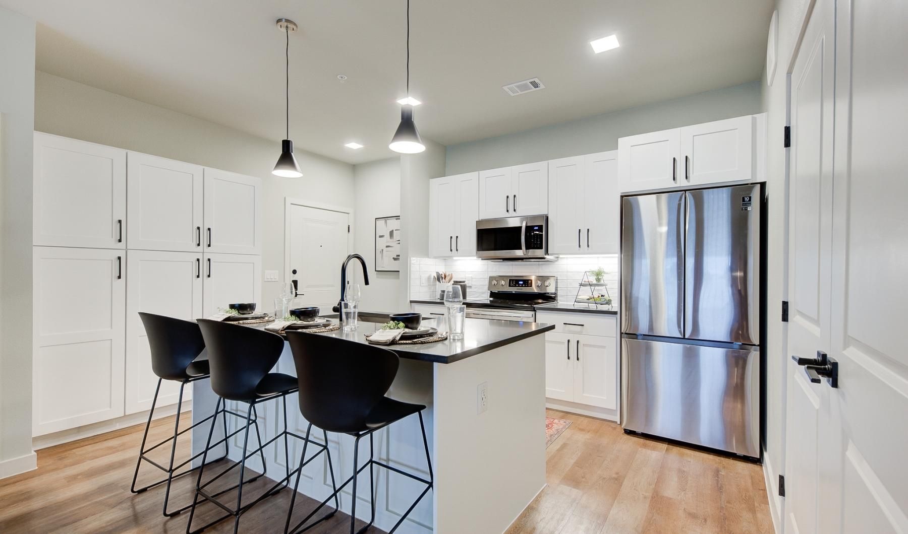 a kitchen with white cabinets