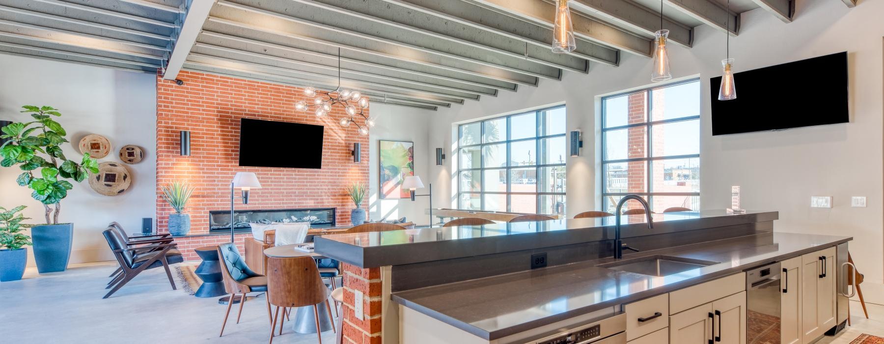a kitchen with a bar and a tv